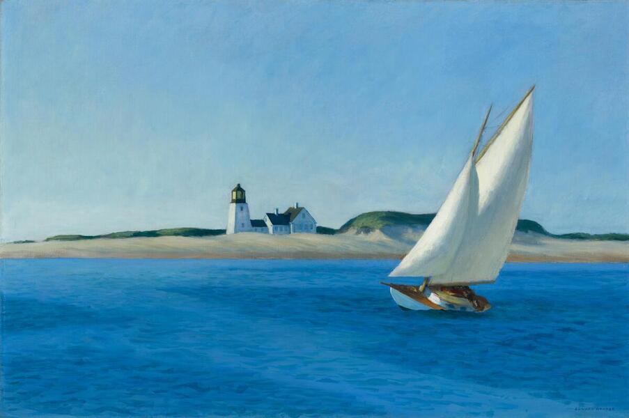 A white sailboat crossing blue water near a lighthouse.